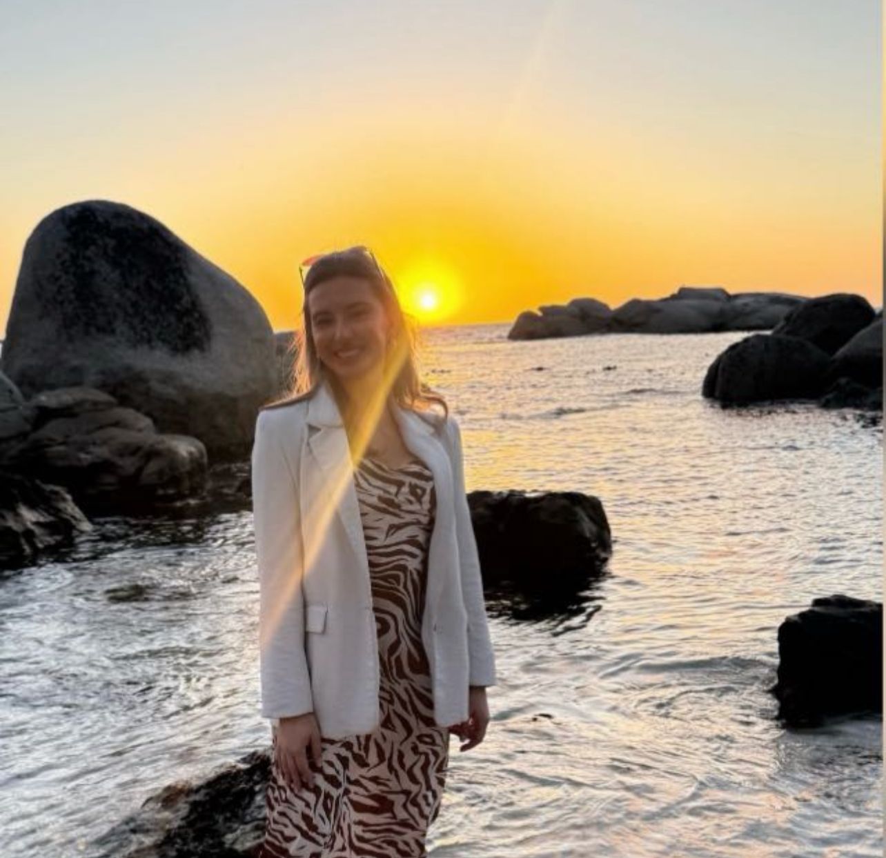 Denicke Nel, founder of HUEMN, at sunset by the ocean in Cape Town